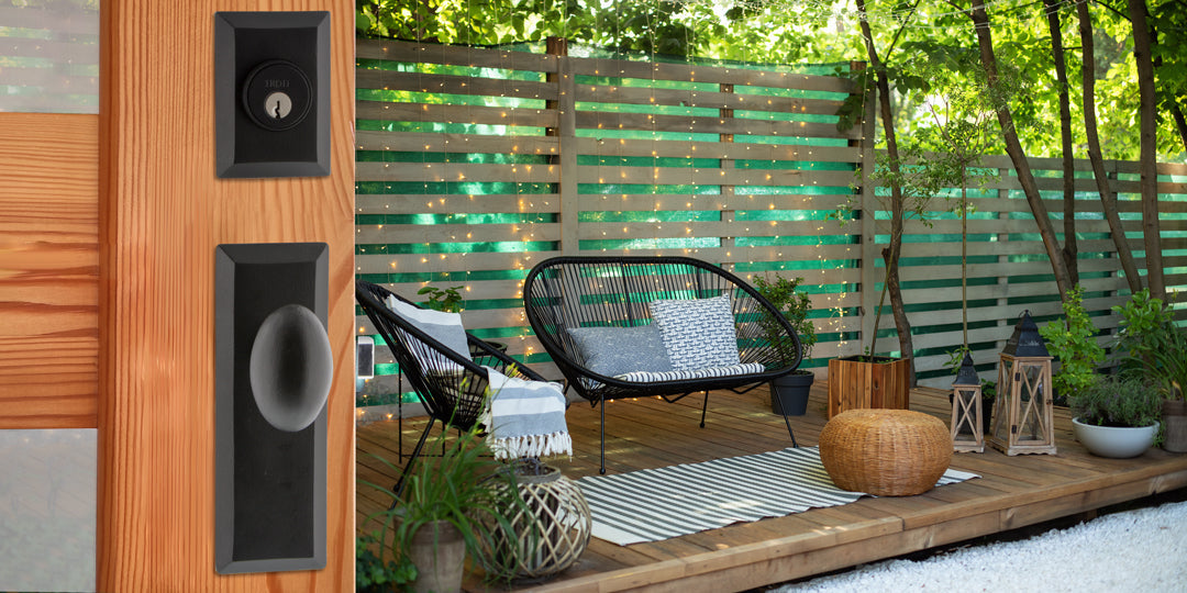 modern back patio with wood deck and a wooden door with windows and black hardware from ageless iron