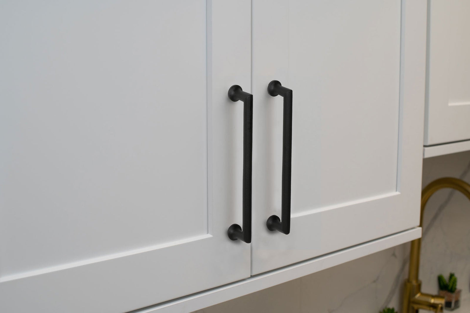 white shaker cabinets with black handle pulls from ageless iron hardware