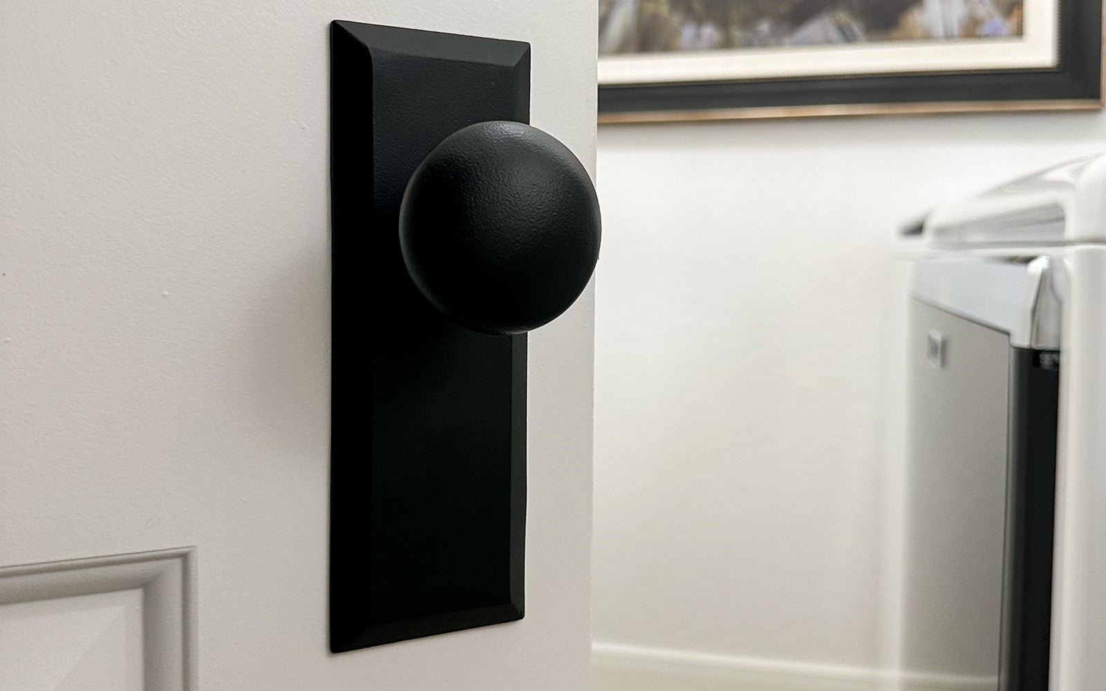 white bathroom door with black iron hardware from ageless iron