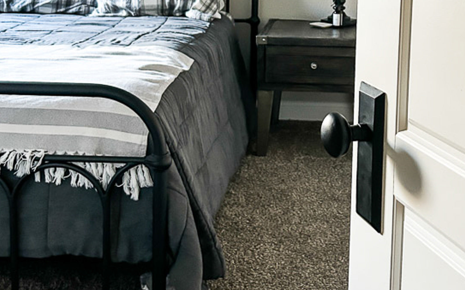 white bedroom door with black farmhouse hardware from ageless iron