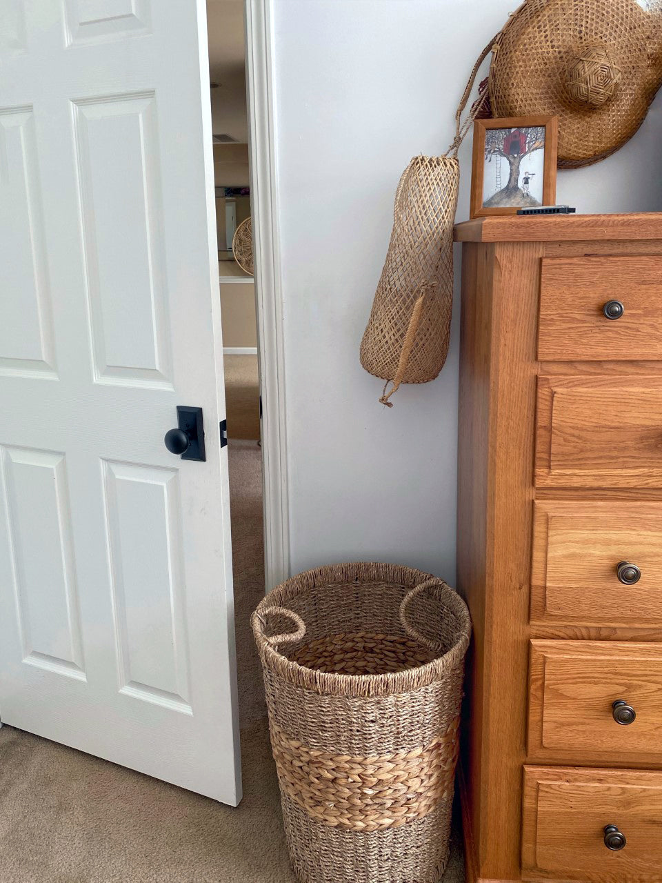 Bedroom door painted crisp white has black Ageless Iron brand door hardware short plate with round knob