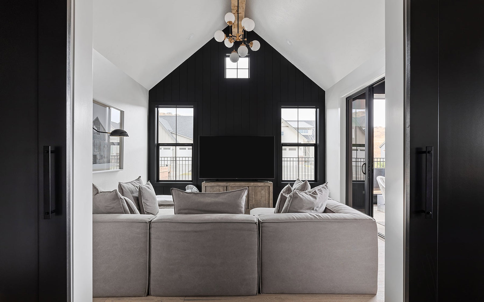 modern farmhouse interior with black cast iron barn door hardware from Ageless Iron separating living room and kitchen