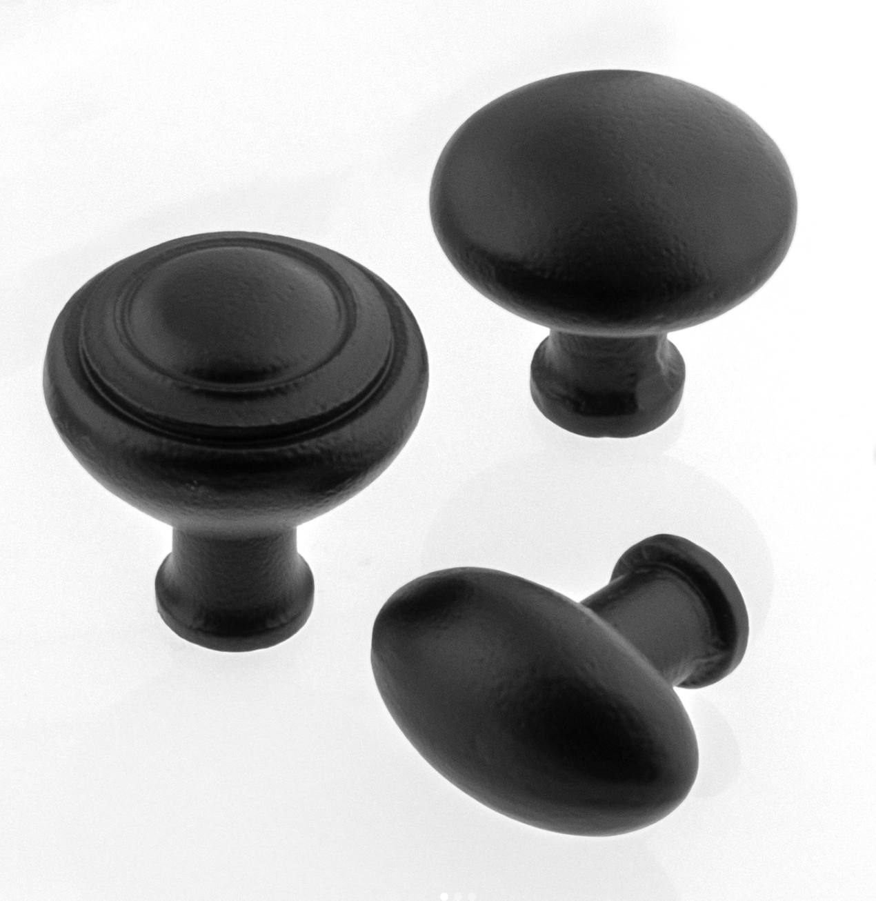 Ageless Iron Keep, Turret, and Aeg Cabinet Knobs in matte black cast iron, grouped together