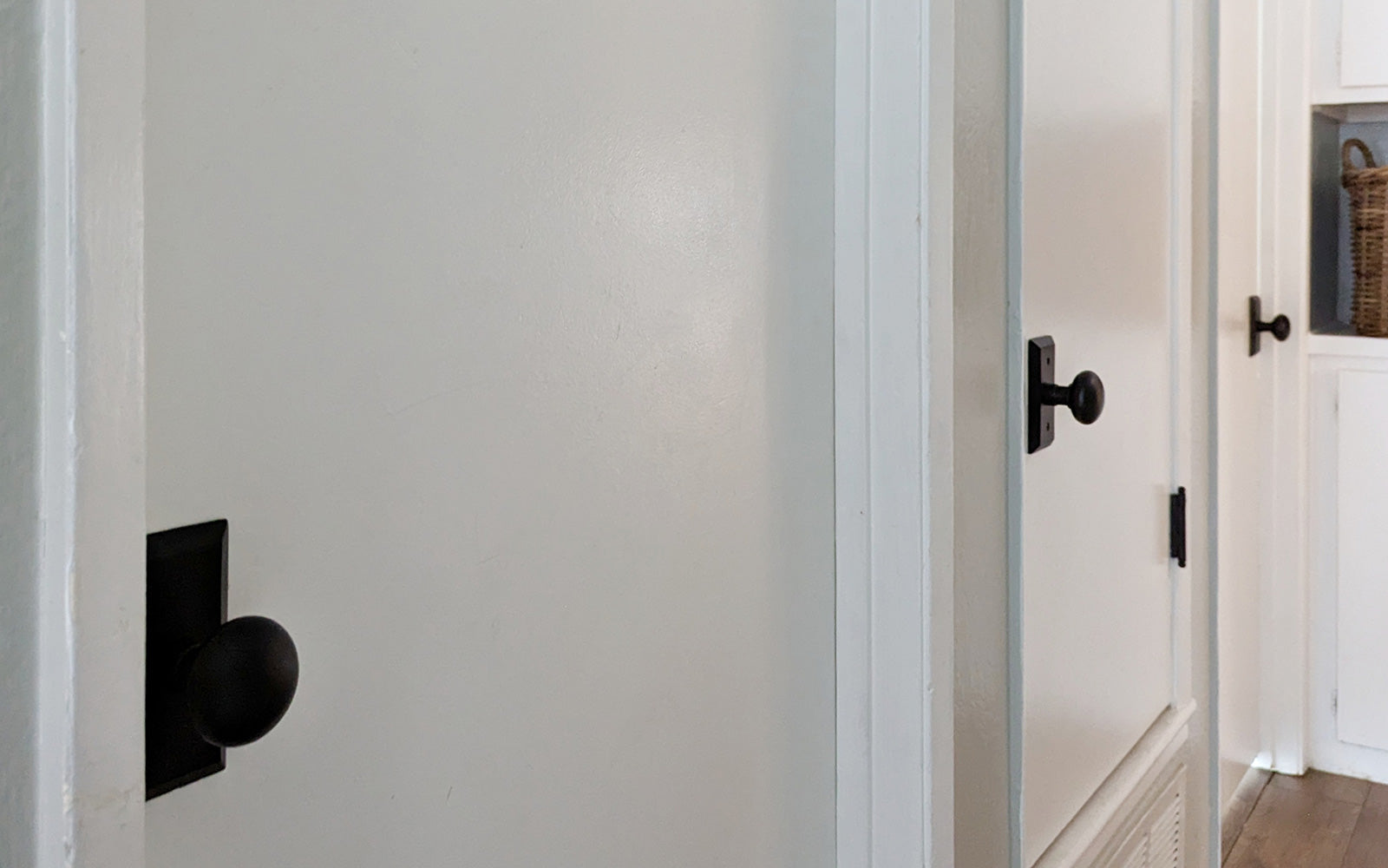 hallway with white doors and black short plate door hardware from ageless iron