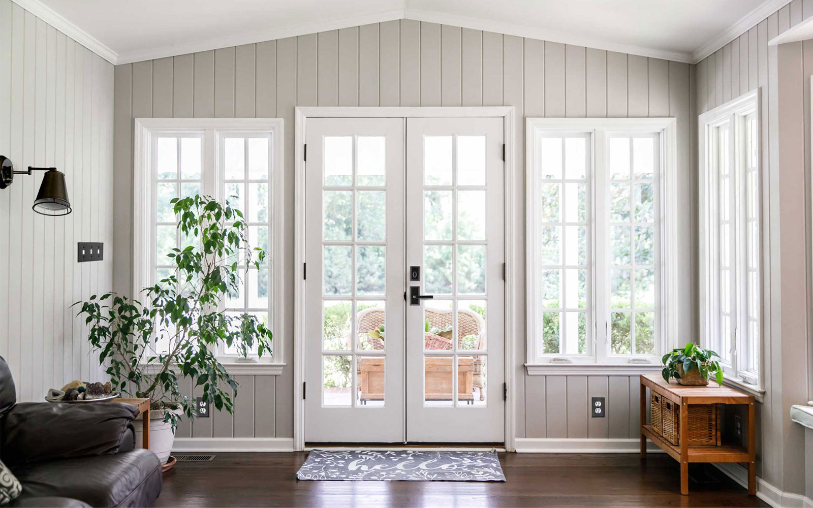 modern farmhouse entryway with white French doors and Ageless Iron matte black cast iron hardware